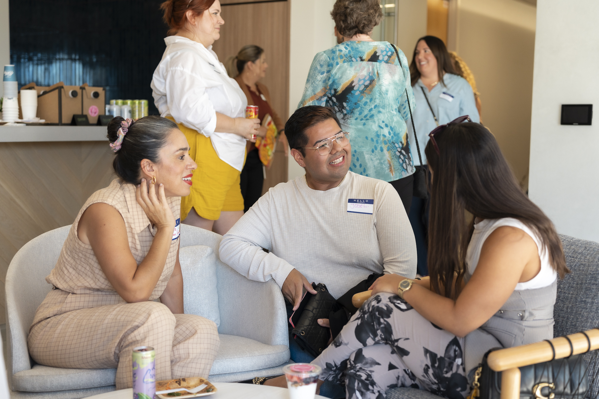 3 individuals sit together chatting.