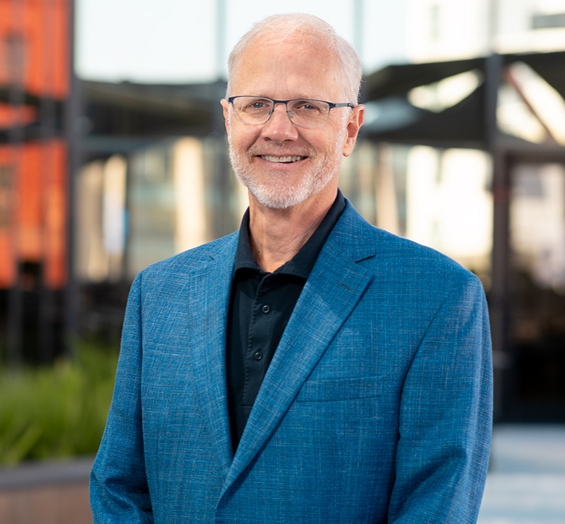 Headshot of Prebys CEO Grant Oliphant smiling at the camera